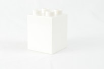 a white box with four white candles in it