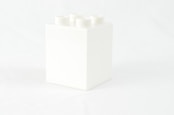 a white box with four white candles in it