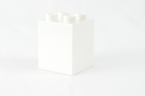 a white box with four white candles in it