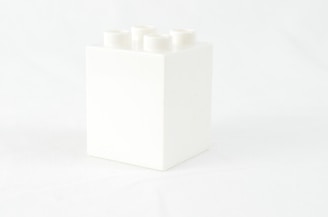 a white box with four white candles in it