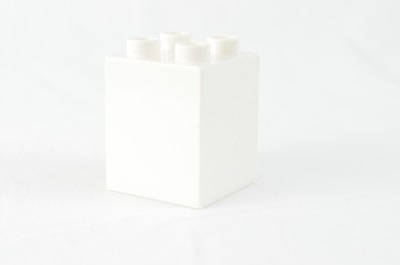 a white box with four white candles in it