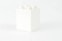 a white box with four white candles in it