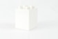 a white box with four white candles in it