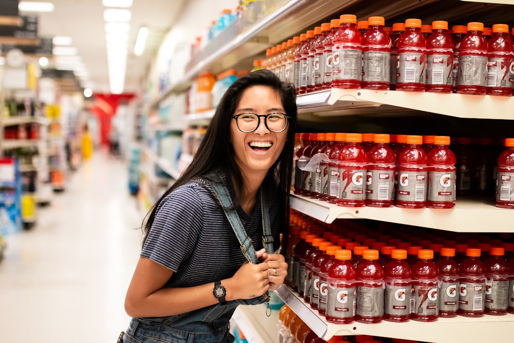 woman laughing while standing beside Gatorade bottlles