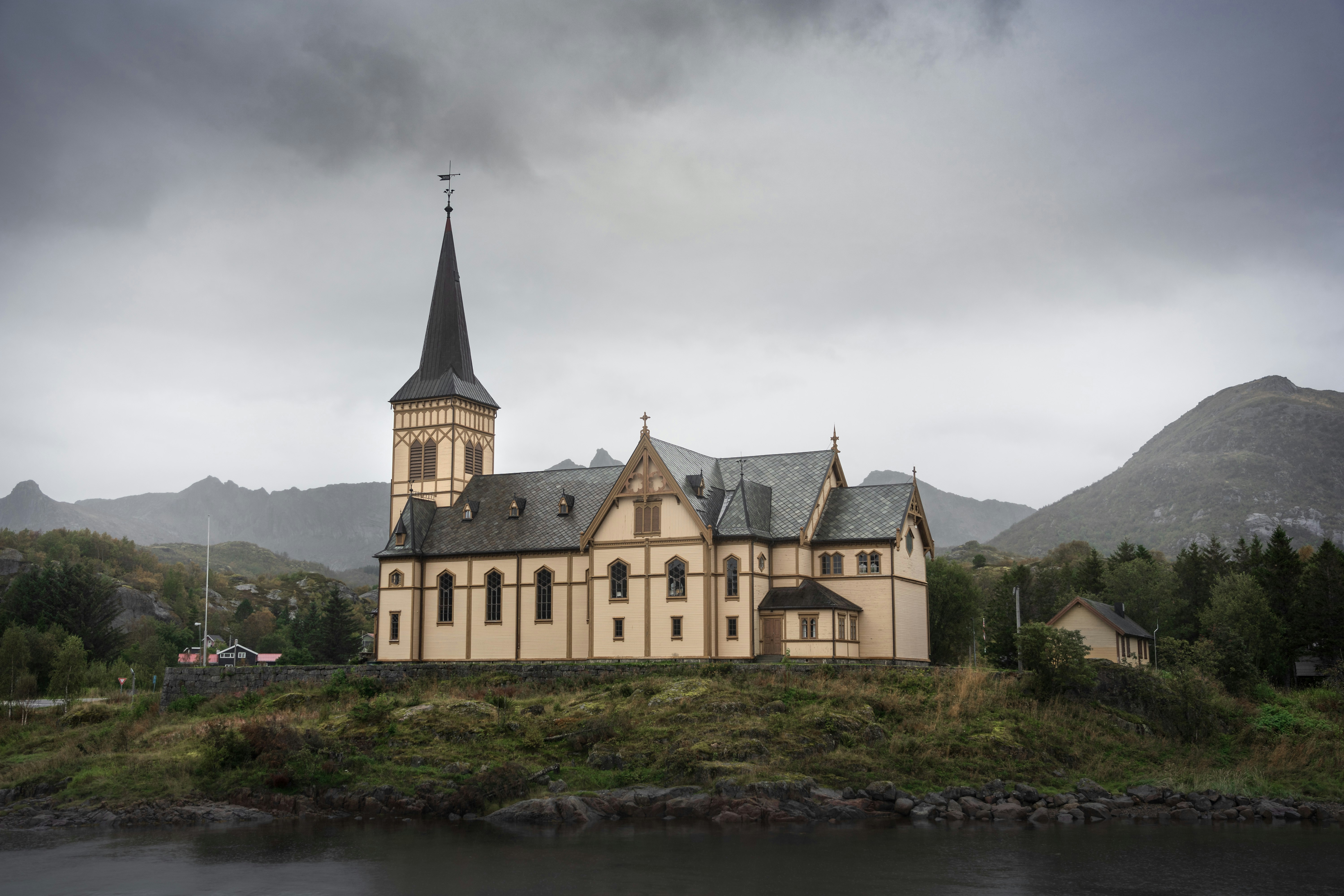 a large building with a steeple on top of a hill