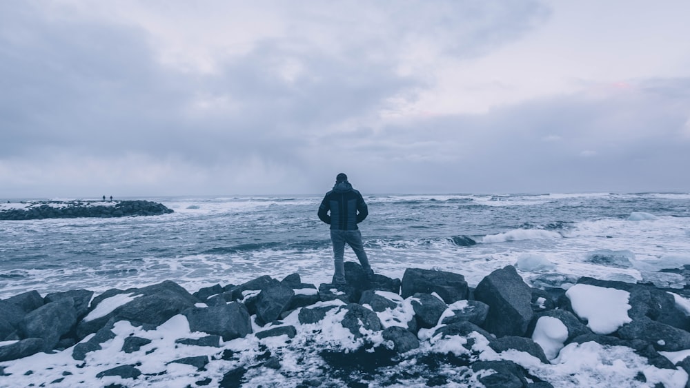 man standing on rocks