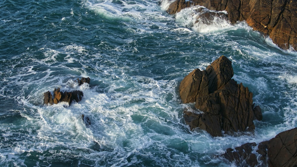 rock formation on body of water