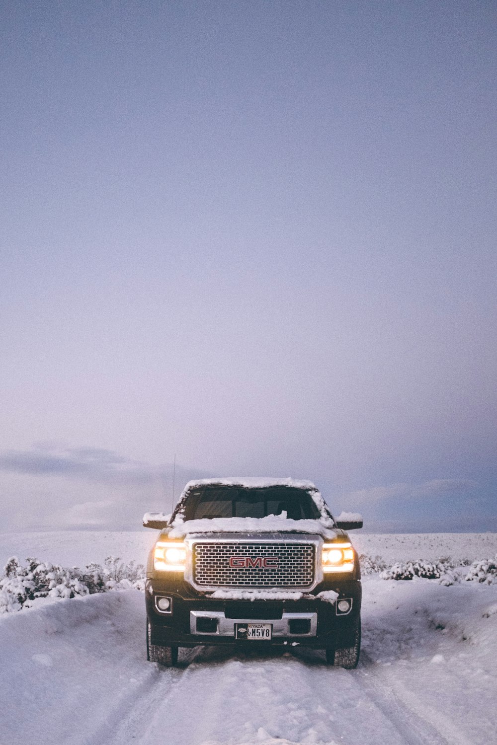 black car travelling on snow