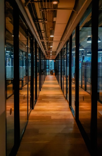 glass paneled long wooden floored hallway