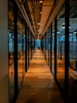 glass paneled long wooden floored hallway