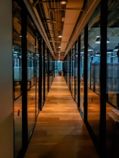 glass paneled long wooden floored hallway