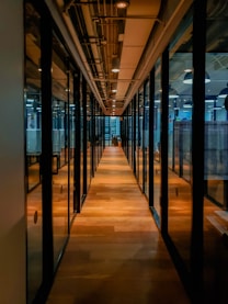 glass paneled long wooden floored hallway