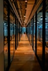 glass paneled long wooden floored hallway