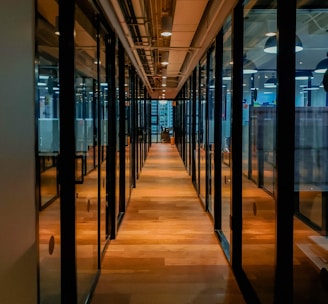 glass paneled long wooden floored hallway