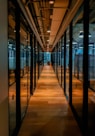 glass paneled long wooden floored hallway