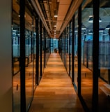 glass paneled long wooden floored hallway