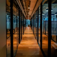 glass paneled long wooden floored hallway