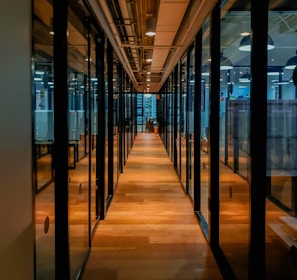 glass paneled long wooden floored hallway