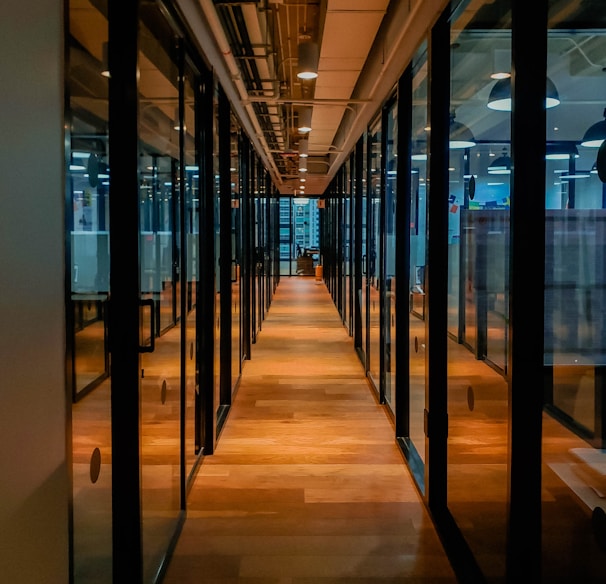 glass paneled long wooden floored hallway