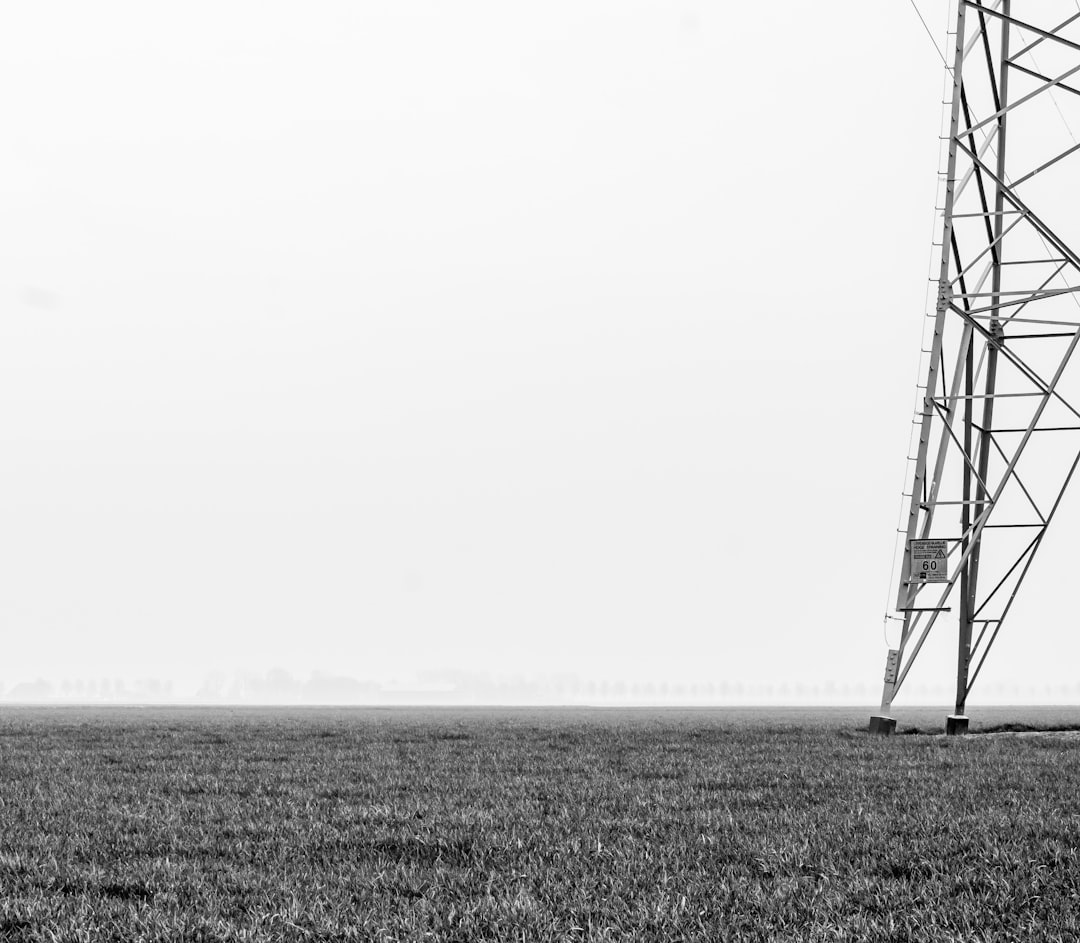 steel transmission tower on grass plains