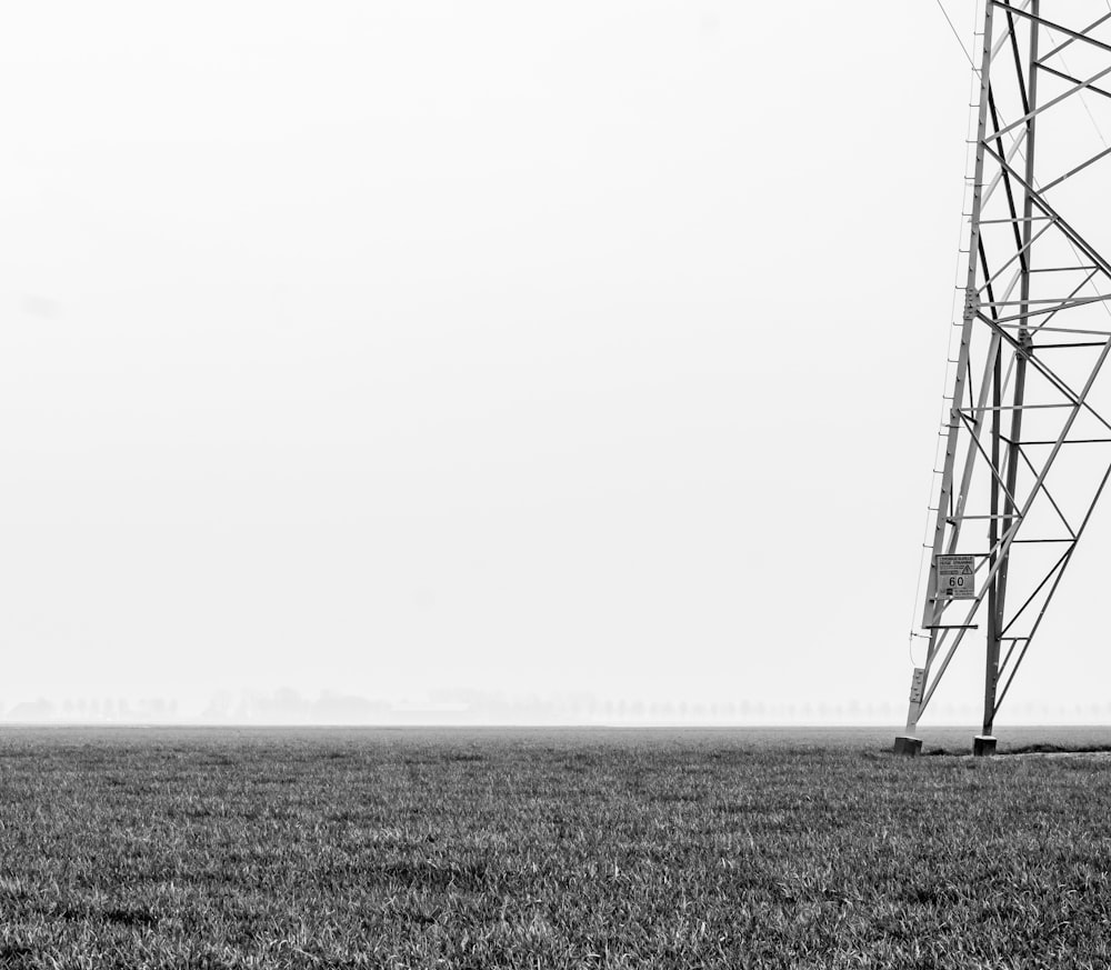 steel transmission tower on grass plains