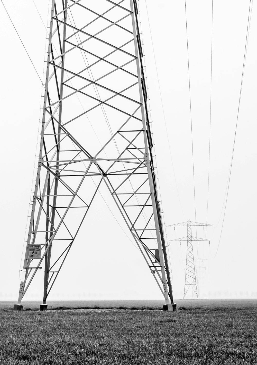 gray transmission towers during daytime