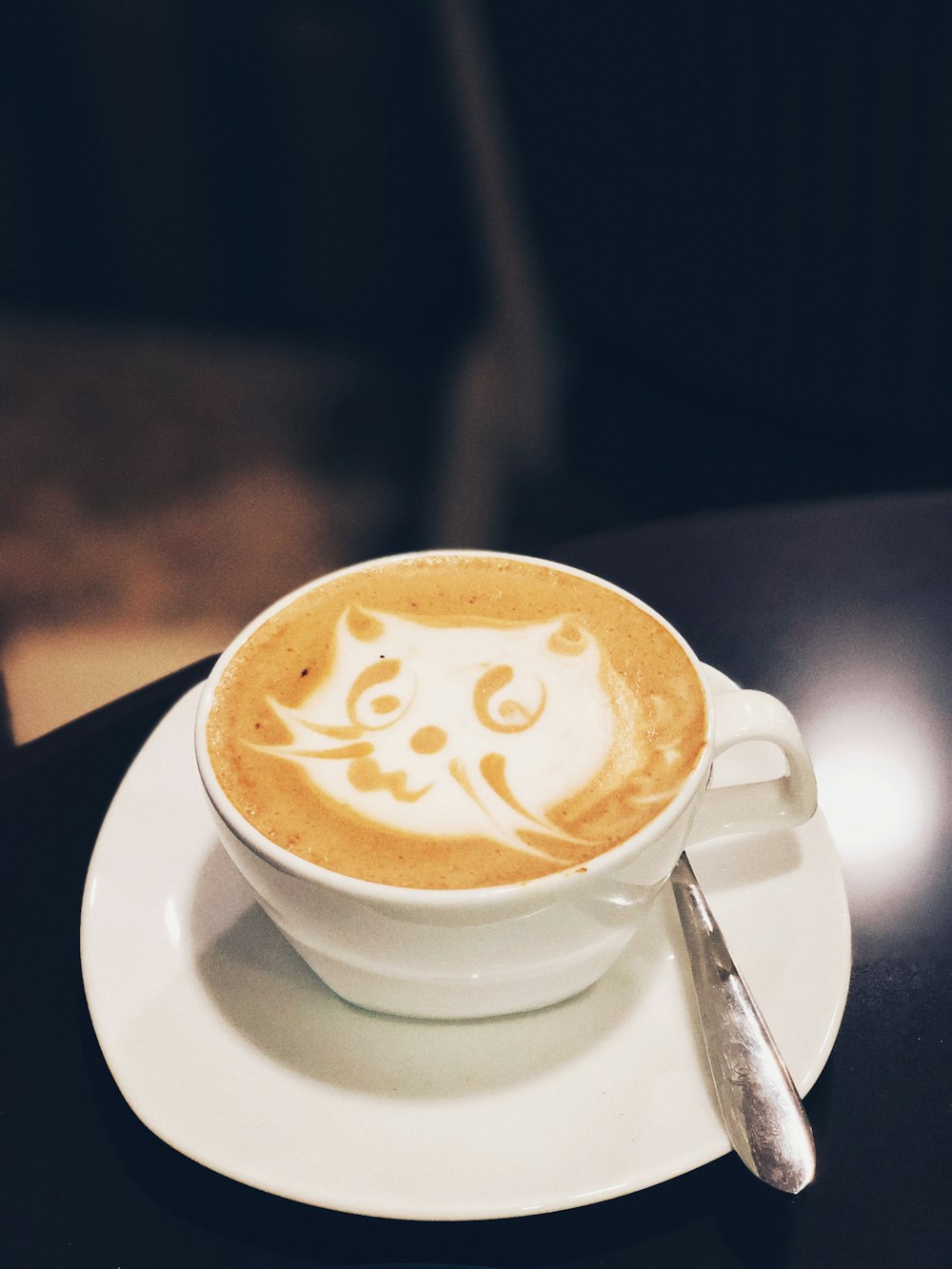 white ceramic teacup with latte art