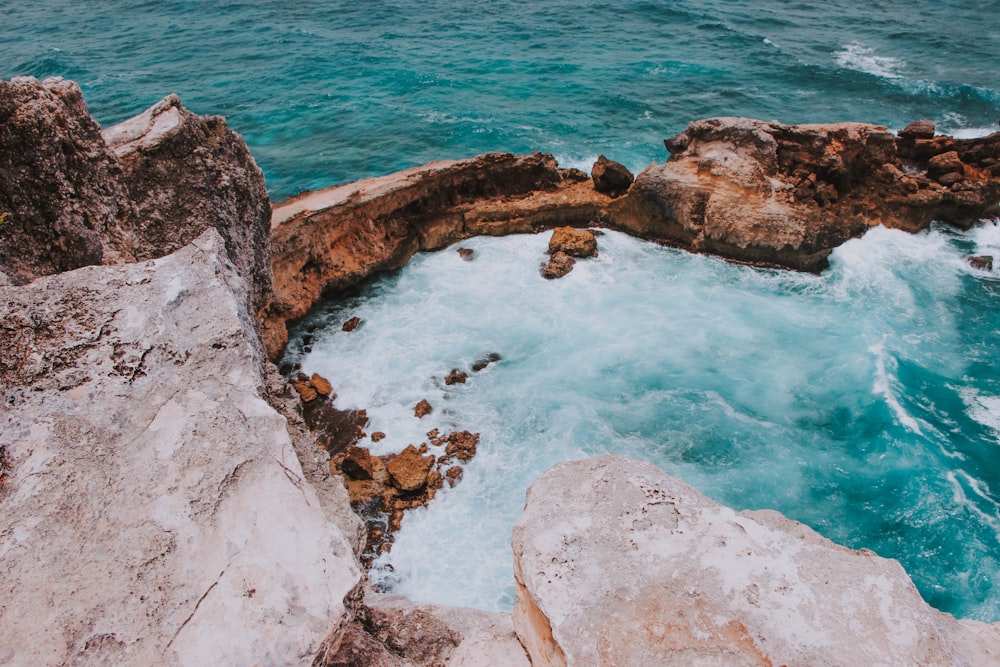 ocean waves crashing on rock formation