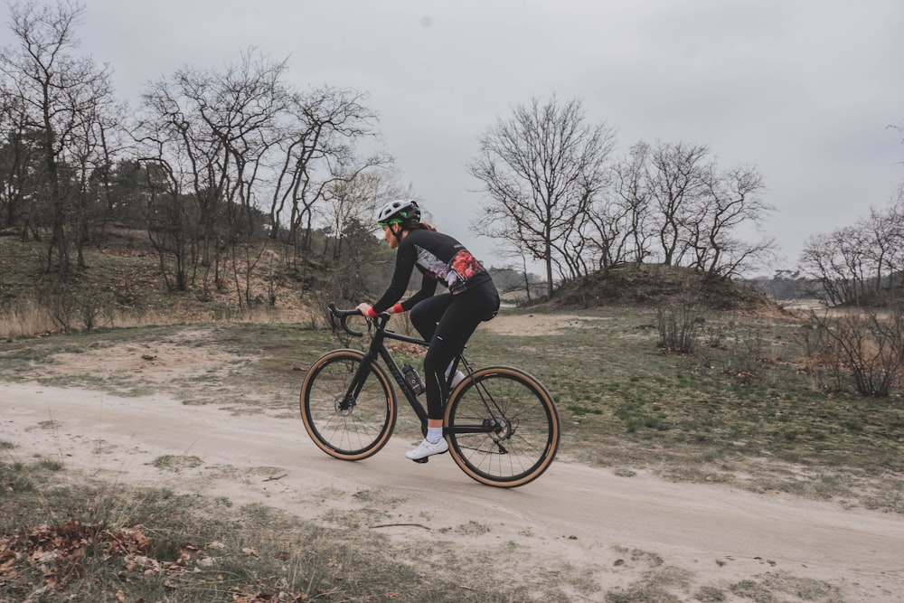 person riding road bike during daytime