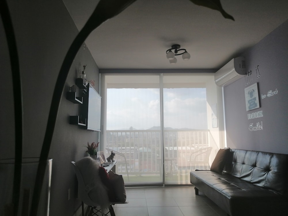 a living room filled with furniture and a large window