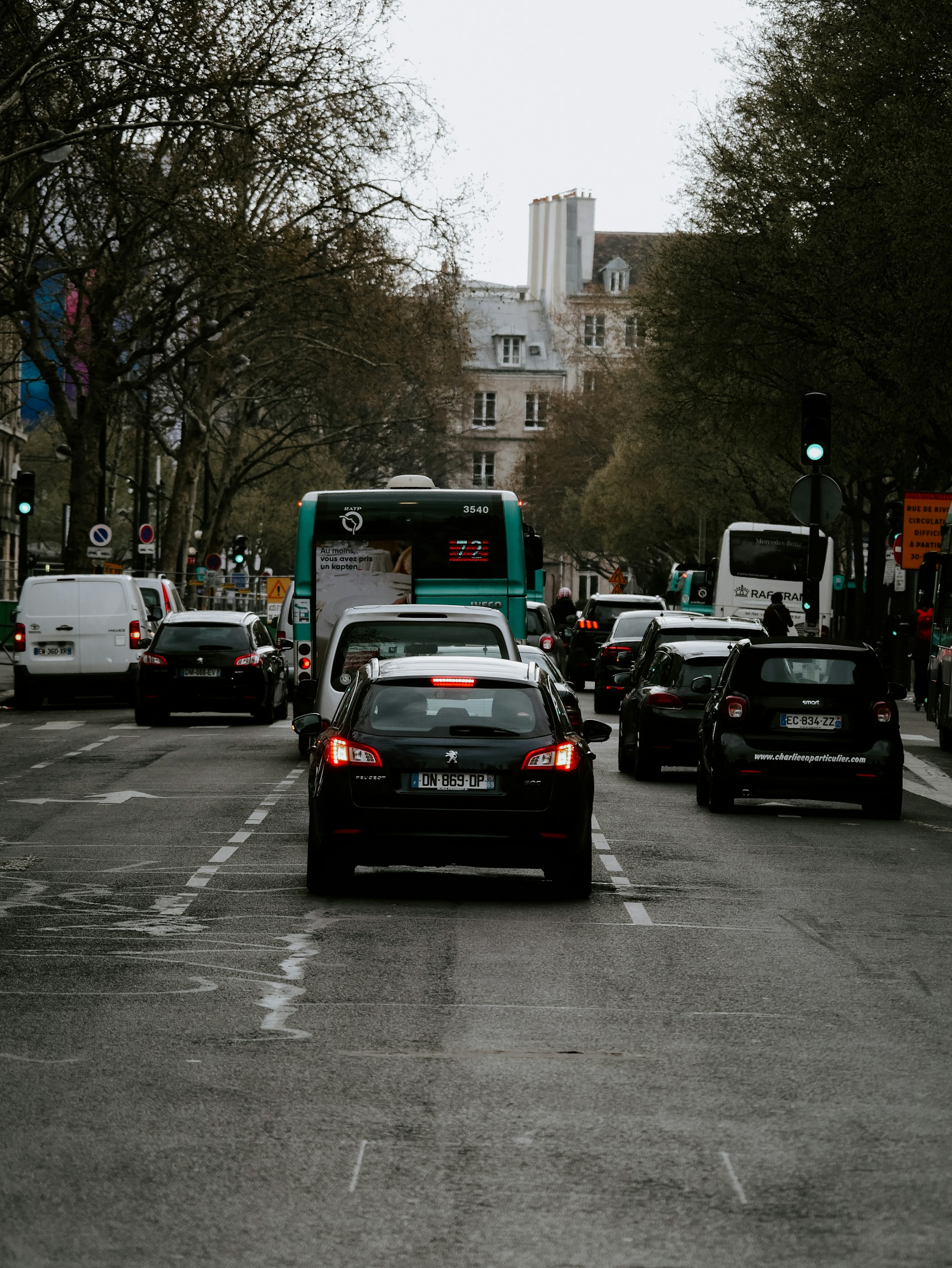 black vehicle on road during daytime