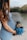 pregnant woman in blue sleeveless dress holding bouquet of flowers