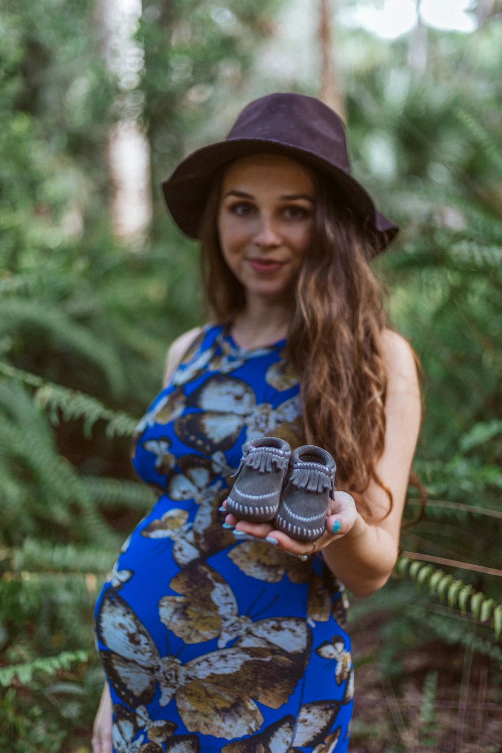 woman holding baby's shoes