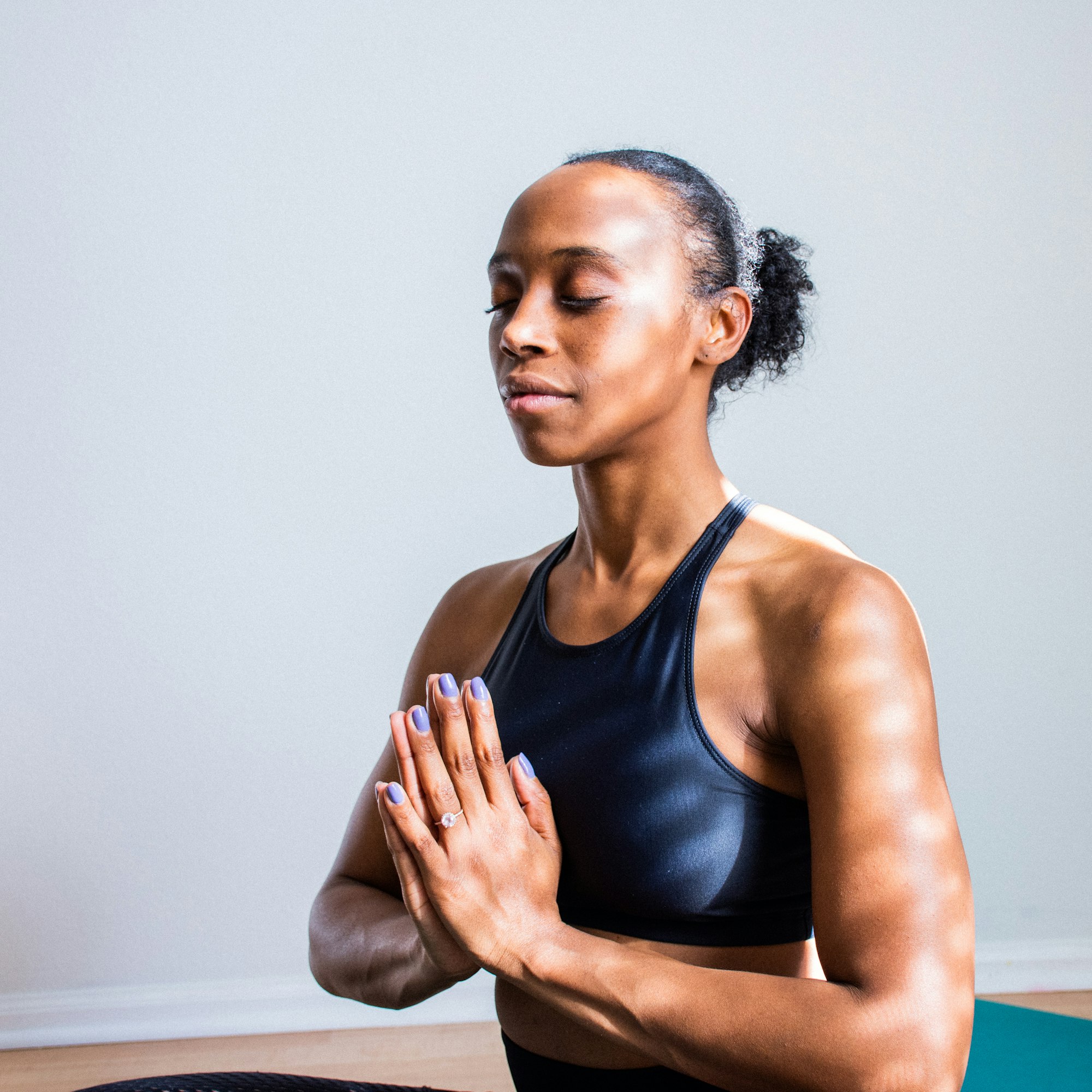 black woman in sportsbar doing meditation