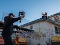 man taking a video of a person on roof