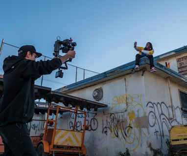 man taking a video of a person on roof