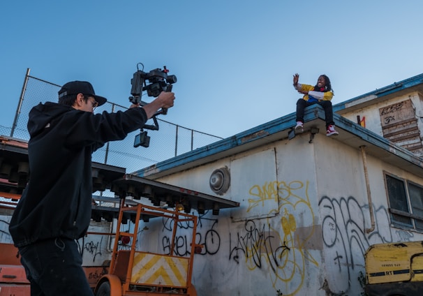 man taking a video of a person on roof