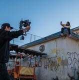 man taking a video of a person on roof