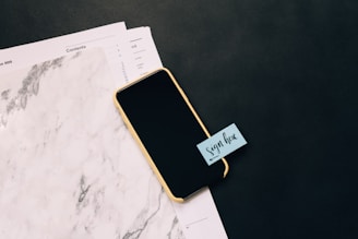 black smartphone on white pad