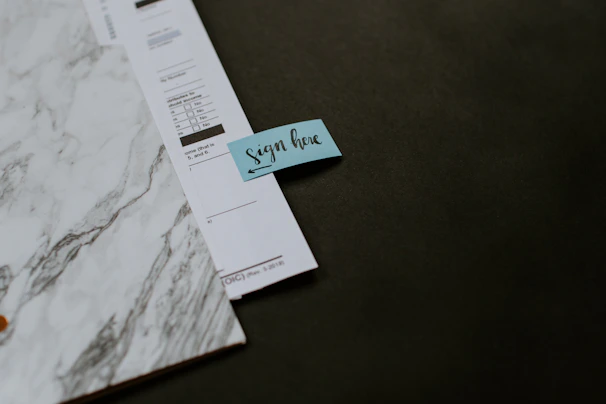 Close-up of a professional stamping an official document with a notary seal.