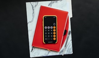 black Android smartphone on red flip case