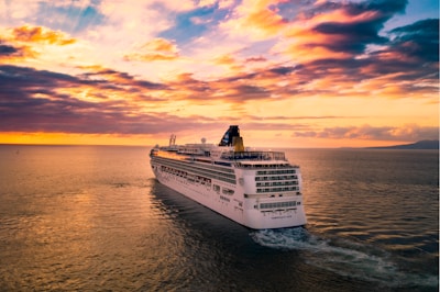 white cruise ship under cloudy sky