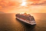 white ship on sea during sunset