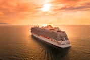 white ship on sea during sunset