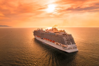 white ship on sea during sunset