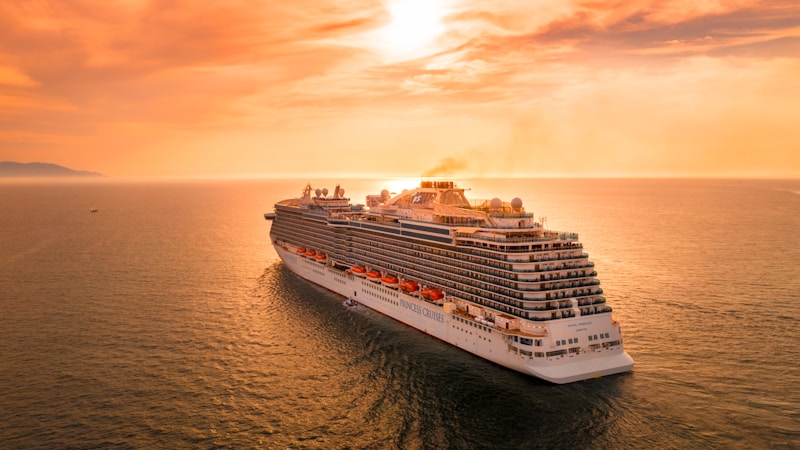 white ship on sea during sunset