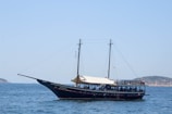 The larger 'Piratas do Porto' schooner sailing peacefully with passengers on board.