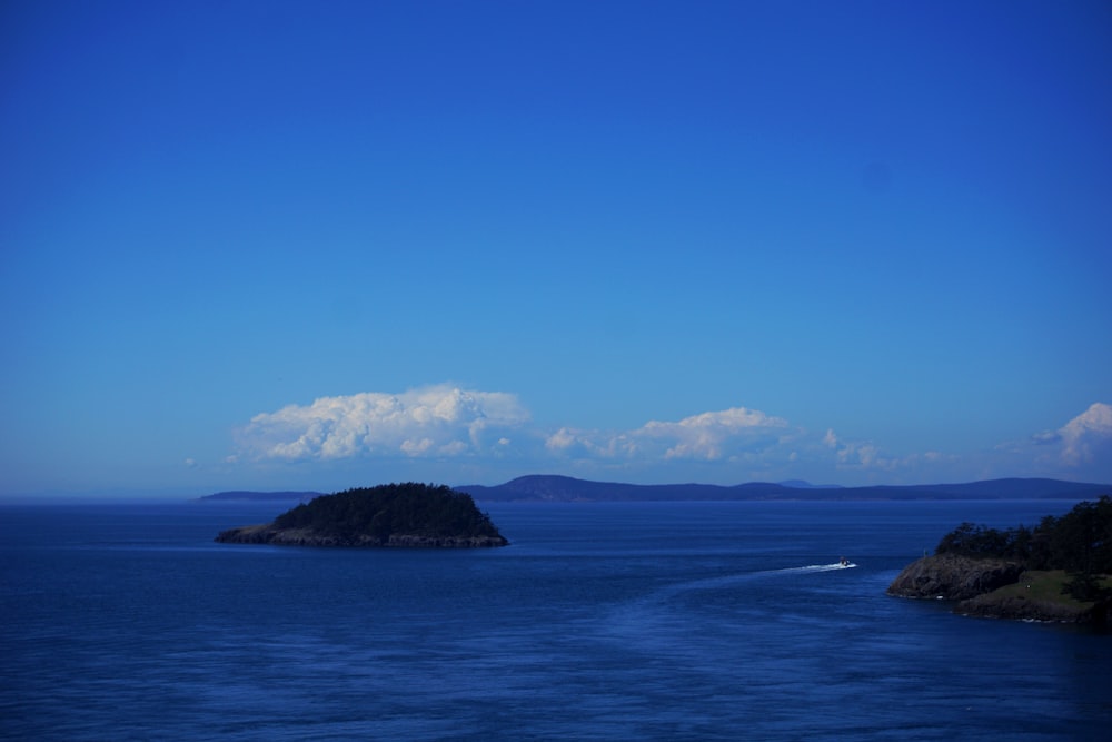 speedboat near island during daytime