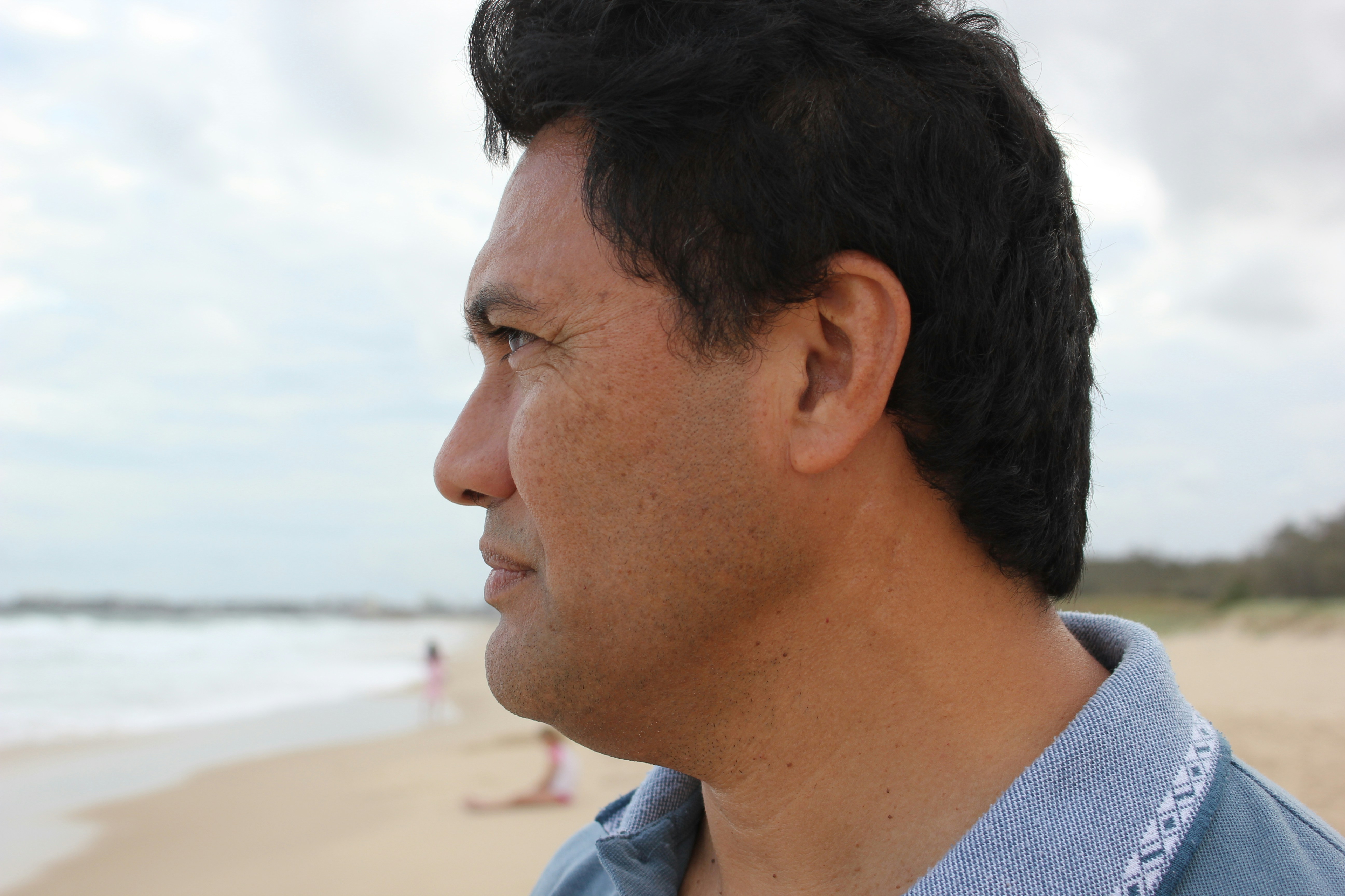 man looking at the beach water