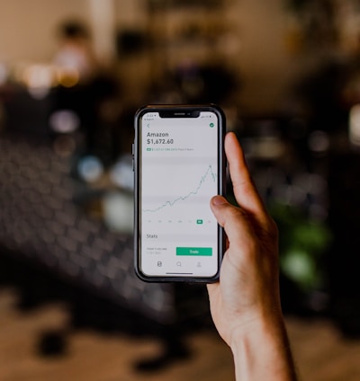 person holding black iPhone displaying stock exchange